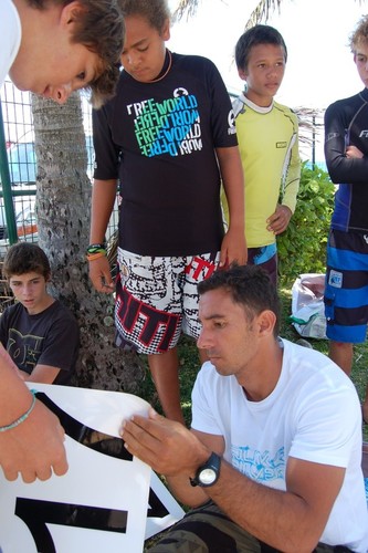 French RS:X sailor/coach Sam Launay tunes and helps local New Caledonian sailors withe their sails. © Brian Haybittle
